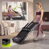 A woman is shown folding a treadmill in a living room, with an inset image showing a woman using the treadmill in a different position. Produktbild-Vorschau