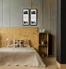 A bedroom with a bed, headboard, and wall decor. Produktbild-Vorschau