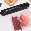 A vacuum sealer machine with food items in sealed bags. Produktbild-Vorschau
