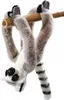 A plush toy lemur hanging upside down from a bamboo pole. Náhľad obrázku produktu