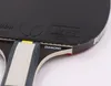 A close-up view of a table tennis racket, showing the rubber surface and part of the handle. Podgląd zdjęcia produktu