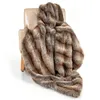 A faux fur blanket draped over a chair. Náhled obrázku produktu