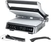 A close-up studio shot of an open electric grill with accessories. Produktbild-Vorschau