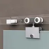 Close-up of a sliding glass door hardware system, showing the track, rollers, and a mounting bracket attached to a glass panel. Produktbild-Vorschau