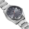 A close-up, angled shot of a men's wristwatch with a gray dial and a metal bracelet, set against a white background. Produktbild-Vorschau