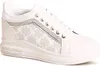 A studio shot of a single white wedge sneaker with beige patterned fabric panels and silver accents. Produktbild-Vorschau