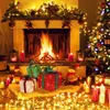 A cozy Christmas scene with a fireplace, decorated tree, and illuminated gift boxes. Podgląd zdjęcia produktu
