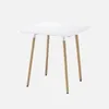 A square white table with wooden legs against a white background. Anteprima dell’immagine prodotto