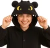 A woman wearing a black dragon-themed onesie costume. Anteprima dell’immagine prodotto