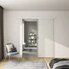 A modern bedroom with a sliding glass door leading to a bathroom. Produktbild-Vorschau