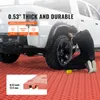A person is working on a white truck parked on red garage floor tiles. The image highlights the thickness and durability of the tiles. Voir les images du produit