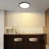 A modern kitchen island with two stools and a ceiling light. Voir les images du produit