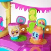 A close-up of a colorful toy playset, likely a pool party theme, featuring animated figures resembling sunscreen bottles and other accessories. Produktbild-Vorschau