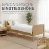 A wooden bed with white bedding in a room with a nightstand and a plant. Produktbild-Vorschau