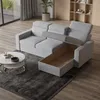 A modern living room with a light gray sectional sofa with an open storage compartment, a round coffee table, and a bookshelf in the background. Produktbild-Vorschau