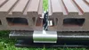 A close-up view of composite decking boards being installed with metal clips. Produktbild-Vorschau