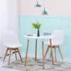 A dining set with a round white table and two white chairs in a room with light blue and pink walls. Náhled obrázku produktu