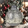 A close-up of a decorative Christmas ornament in front of a blurred Christmas tree. Produktbild-Vorschau
