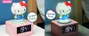 A collage showing a pink Hello Kitty digital alarm clock with two different views: one with the night light off and one with the night light on. Text overlays highlight features. Podgląd zdjęcia produktu