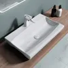 A white ceramic washbasin with a modern faucet is placed on a wooden countertop. Produktbild-Vorschau