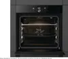 An open oven with its interior visible, showing racks and a fan. Produktbild-Vorschau