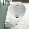 A modern white sink with a chrome faucet mounted on a light green wall. Produktbild-Vorschau