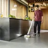 A man is cleaning a modern kitchen floor with a cordless floor cleaner. Anteprima dell’immagine prodotto