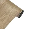 A roll of self-adhesive wood-effect vinyl wrap is shown against a white background. Anteprima dell’immagine prodotto