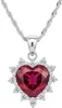 A close-up studio shot of a heart-shaped ruby pendant necklace with surrounding clear stones, set against a white background. Podgląd zdjęcia produktu