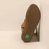 The sole of a brown boot is leaning against a white wall. Voir les images du produit