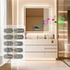 A modern bathroom vanity with a lit mirror displaying musical notes and feature icons. Anteprima dell’immagine prodotto