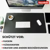 A desk setup with a computer monitor, keyboard, mouse, headphones, and a cup of coffee on a black desk mat. Anteprima dell’immagine prodotto