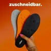 Drei Einlegesohlen in Schwarz, Orange und Grau, von einer Hand gehalten, mit Text 'kürzbar' darüber Produktbild-Vorschau