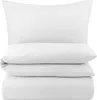 A stack of white bedding items, including a pillow and folded duvet or sheets, presented on a white background. Produktbild-Vorschau