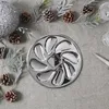 A silver oyster serving platter is placed on a grey tablecloth, surrounded by pine cones and evergreen branches. Voir les images du produit