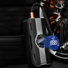 A portable tire inflator is shown next to stacked tires and a car wheel. Produktbild-Vorschau