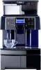 A professional coffee machine with water and bean reservoirs, a control panel, and a brewing spout over a glass cup. Podgląd zdjęcia produktu