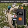 Two people cycling on a mountain trail with a portable air compressor in the foreground. Produktbild-Vorschau