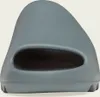 A close-up, front-facing view of a single gray slide sandal. Produktbild-Vorschau