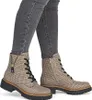 A pair of women's boots worn by a person. Voir les images du produit