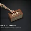 A tattooed arm is adjusting the knobs on a brown Marshall speaker. Produktbild-Vorschau