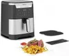 An air fryer with a plate of food in front of it. Voir les images du produit