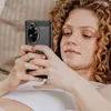 A woman is lying down and holding a smartphone. Náhľad obrázku produktu