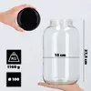 A hand holds a black lid over a large glass jar, with dimensions and weight indicated by icons and text. Podgląd zdjęcia produktu