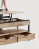 A person's arm is shown adjusting the height of a lift-top coffee table. Náhľad obrázku produktu