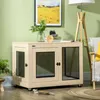 A dog crate is placed in a living room setting, next to a chair and a floor lamp, with a painting on the wall. Náhled obrázku produktu
