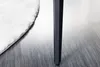 A close-up shot of a table leg and a rug on a wooden floor. Produktbild-Vorschau