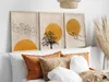 Three framed abstract art pieces are displayed on a wall above a bed with several pillows. Anteprima dell’immagine prodotto