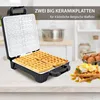 A waffle maker with waffles and toppings on a kitchen counter. Podgląd zdjęcia produktu