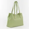 A light green tote bag is shown from a side angle against a white background. Produktbild-Vorschau